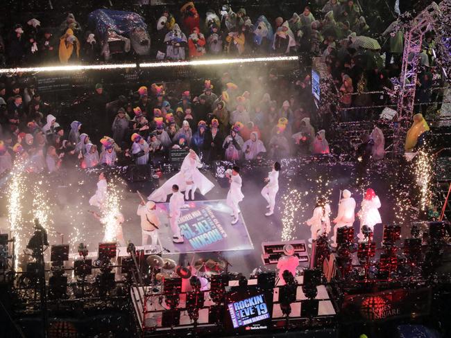 Revellers watch Christina Aguilera perform as they wait for midnight during the New Year's Eve celebration in New York's Times Square.  Picture: AP