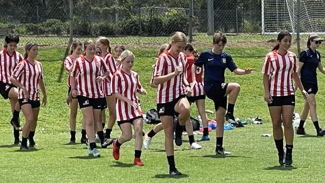 Sierra McCaffrey, far right, warming up last week next to her Kelvin Grove junior girls team mates.