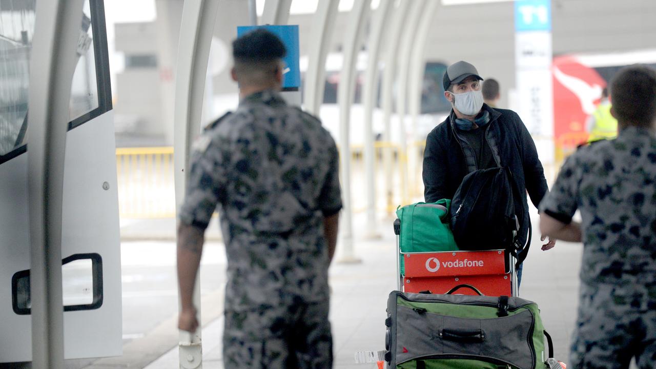 Returning international travellers are ushered into buses for hotel quarantine at Sydney International Airport. Picture: NCA NewsWire / Jeremy Piper