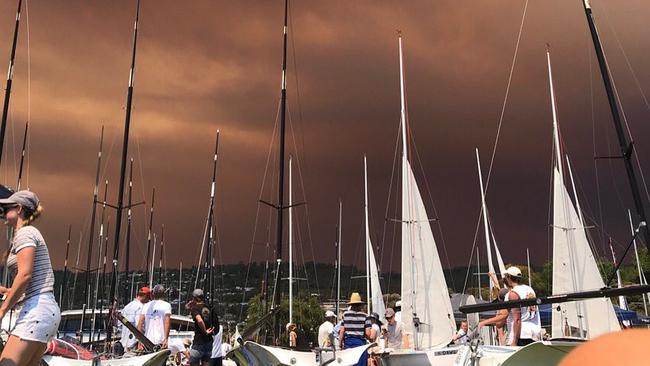 Intense skies over the Royal Tasmania Yacht Club in Sandy Bay, 04-01-2019, due to fires southwest of Hobart. Picture: Twitter/@clearairsailing