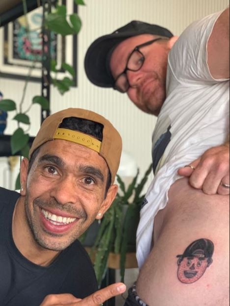 Eddie Betts brother-in-law Tom gets a tattoo of Eddie's face on his butt cheek at the Golden Crow Electric Tattoo. Picture: Instagram