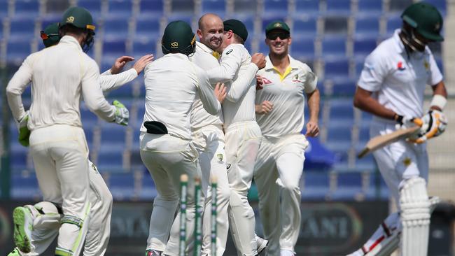 Nathan Lyon celebrates with teammates after dismissing Babar Azam for a duck. Picture: Getty