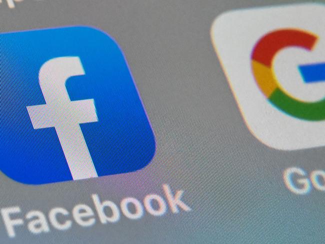 (FILES) In this file photo illustration taken on October 01, 2019, shows the logos of mobile apps  Facebook and Google displayed on a tablet in Lille France. - Facebook and Google have extended their bans on political ads in the US amid misinformation circulated aimed at bolstering claims by President Donald Trump of fraud in his loss to Joe Biden. (Photo by DENIS CHARLET / AFP)