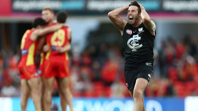 An angry Dale Thomas after the final siren as Suns players celebrate the win. Picture: Getty