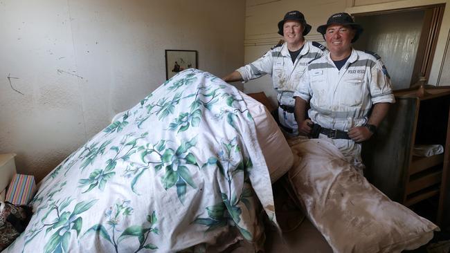 Police Rescue senior constables Ben King and Adam Davis after they rescued her from her home in South Lismore. Picture: Toby Zerna