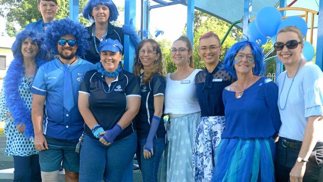 Brenda Venter, Stacey Walsh, Matt O'Brien, Sam Avery, Anne-Marie Johnstone, Susan Neill, Claudia Mullen, Clancy Conlon, Donna Purcell, and Helen Reece of Autism Queensland go blue for Autism Month. Picture: Jann Houley