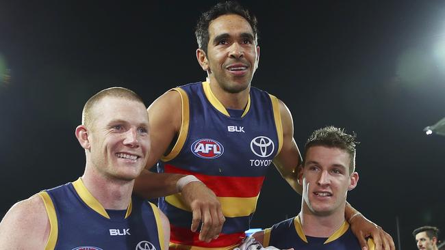 Eddie Betts is chaired off Adelaide Oval by Sam Jacobs and Josh Jenkins. Jenkins says an object thrown towards Betts during the game was a banana. Picture: Sarah Reed