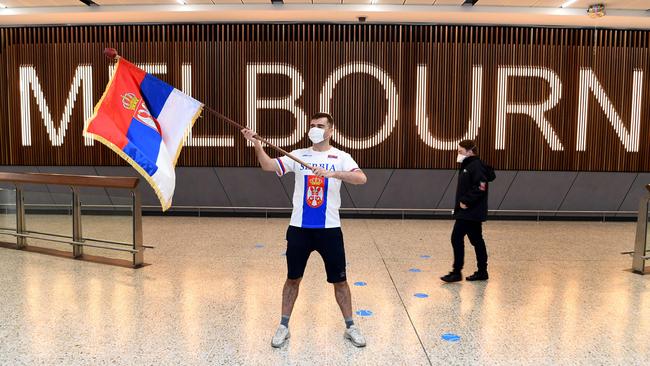 A Serbian tennis fan waves a flag as he awaits the arrival of Serbia's tennis champion Novak Djokovic in Melbourne.