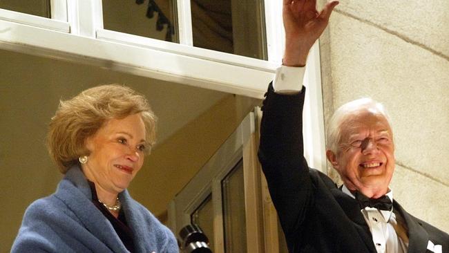 Mr Carter and his wife Rosalynn salute a crowd gathered outside his hotel in central Oslo, Norway, after he had been awarded the 2002 Nobel Peace Prize. Picture: AP