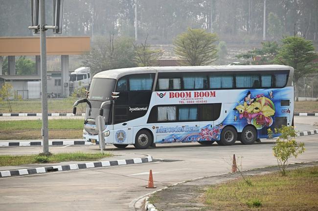 A bus carrying alleged scam centre workers and victims from China handed over from Myanmar arrives at the Mae Sot border checkpoint with Thailand