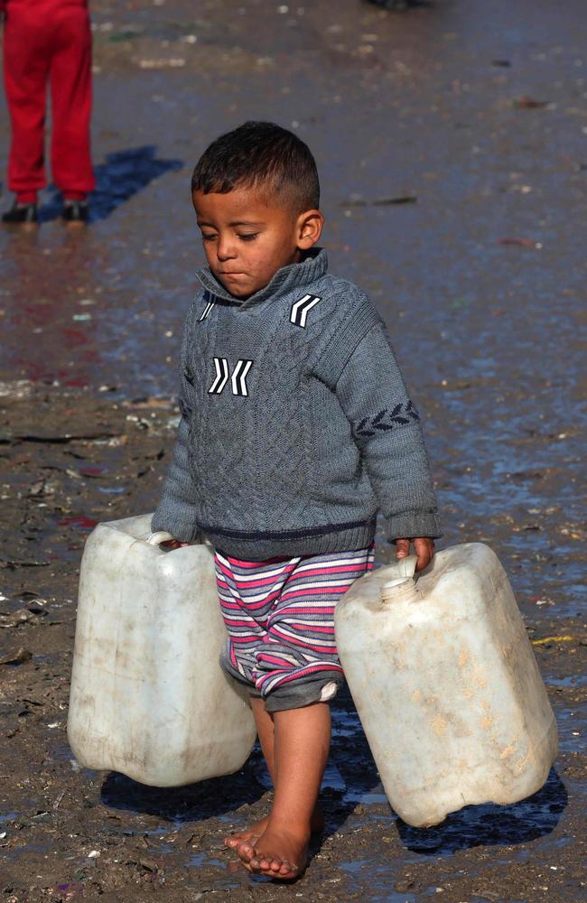 A young boy carries empty jerricans in Rafah in the southern Gaza Strip. Picture: Mohammed Abed/AFP