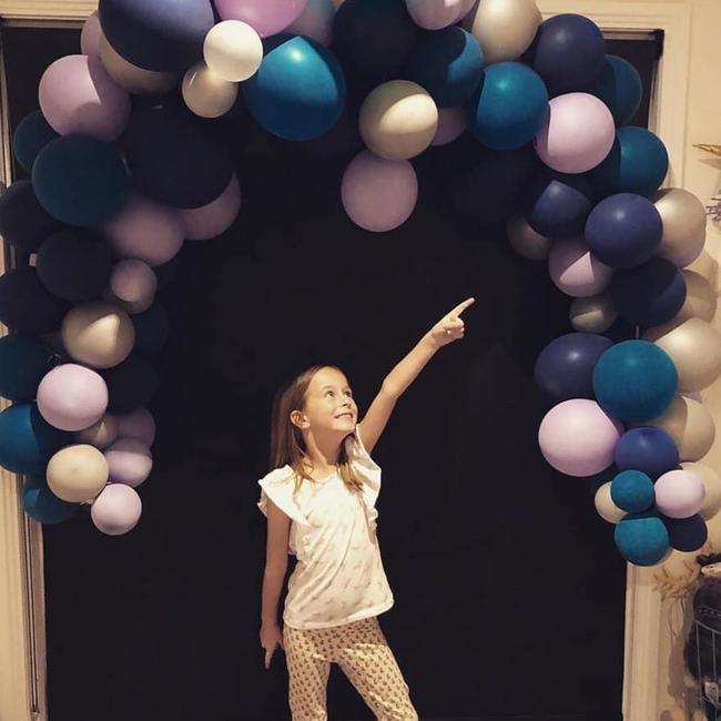 Suzanne Wood’s daughter poses with the balloons before they are recycled.