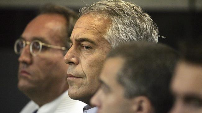 FILE - In this July 30, 2008 file photo, Jeffrey Epstein, center, appears in court in West Palm Beach, Fla. The wealthy financier pleaded not guilty in federal court in New York on Monday, July 8, 2019, to sex trafficking charges following his arrest over the weekend. Epstein will have to remain behind bars until his bail hearing on July 15. (Uma Sanghvi/Palm Beach Post via AP, File)