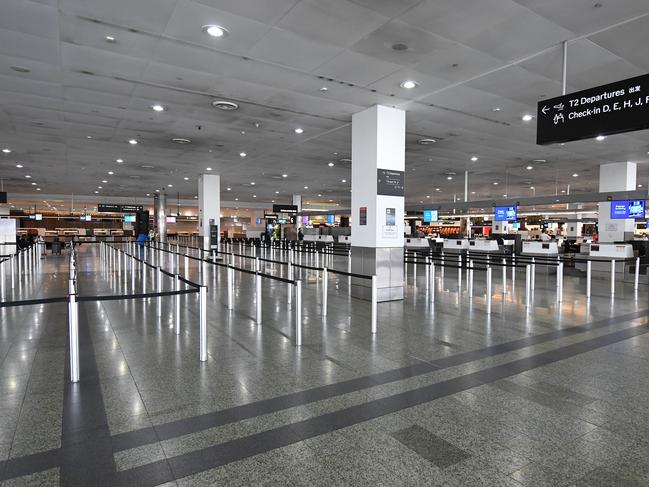 General view of empty baggage check-in lines inside in International terminal at Tullamarine Airport, Melbourne, Friday, March 13, 2020. (AAP Image/James Ross) NO ARCHIVING