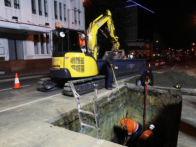 Work in Macquarie St, Hobart, digging the hole that will house the chamber that performance artist Mike Parr will live in for 72 hours during Dark Mofo. Picture: NIKKI DAVIS-JONES