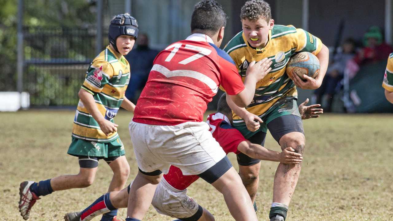 BIG RUN: Darling Downs under-12 player Oliver Dunk takes on the Brisbane Red line during the Queensland Rugby Union Junior State Championships. Picture: Nev Madsen