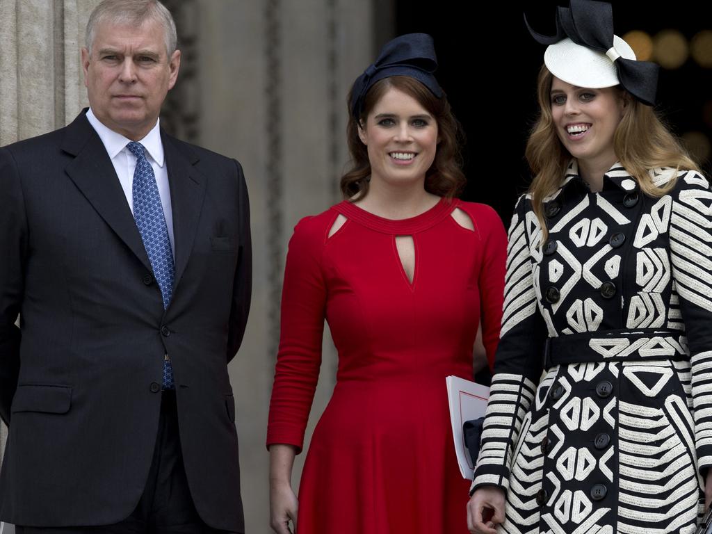 Prince Andrew with Princess Eugenie and Princess Beatrice. Picture: AFP