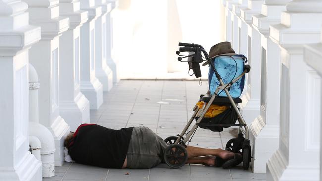 A homeless man sleeps rough in front of an office building on Abbott Street in the Cairns CBD. Picture: Brendan Radke