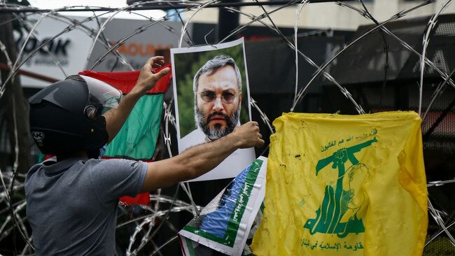 A demonstrator in Lebanon displays a photo of Hezbollah leader Imad Mughniyeh, assassinated in Syria in 2008. Picture: Getty Images