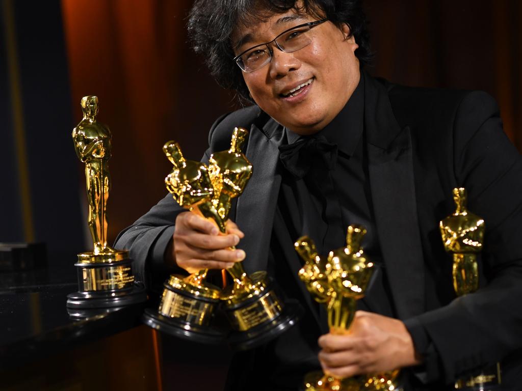 South Korean film director Bong Joon Ho poses with his engraved awards as he attends the 92nd Oscars Governors Ball. Picture: AFP