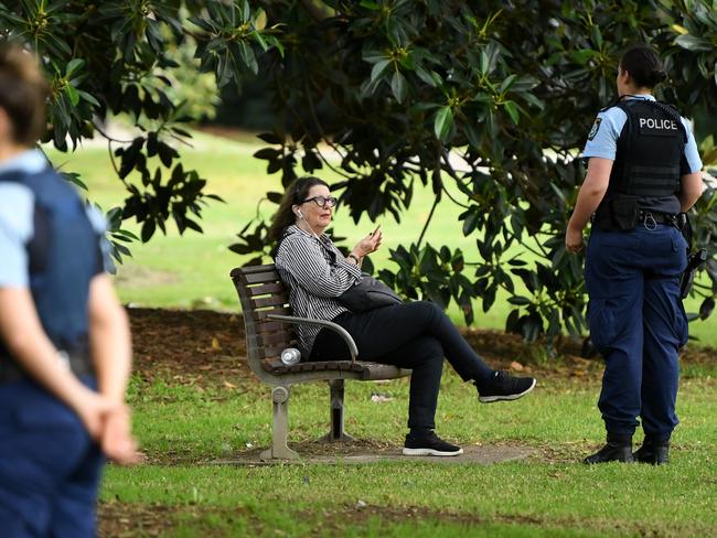 NSW police officers ask a woman to move on while on patrol at Rushcutters Bay. Picture: AAP