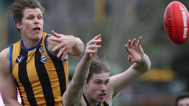 Old Carey’s Ben Coull and St Bernard’s Shaun Clarke lock horns. Picture: David Crosling