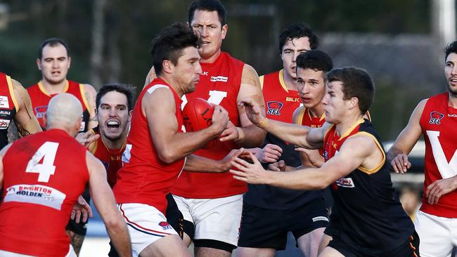 Players from East Brighton and Dingley throw themselves at the contest Picture: Paul Loughnan.