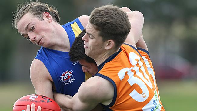 TAC Cup footy: Calder Cannons v Western Jets. Jets player Luke Hitch is tackled by Jonah Hero and Mitchell Podhajski. Picture : Ian Currie