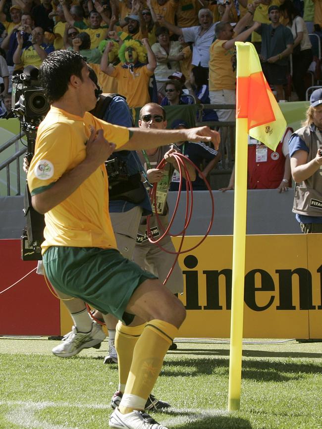 Tim Cahill celebrates at the corner flag after scoring against Japan