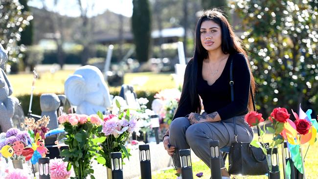 Ms Chalmers sits by her daughter’s grave. She named the baby Adeya. Picture: Jeremy Piper