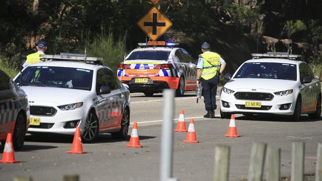 The law requires motorists to slow down to 40km/h when emergency vehicles or police cars are stationary on the side of the road. Picture: Dylan Robinson