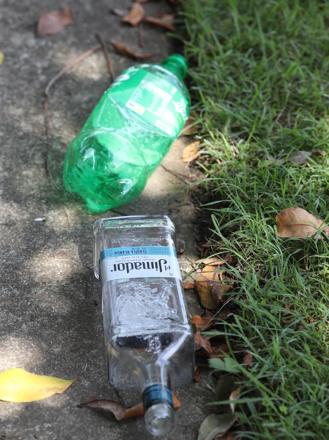 Empty vodka bottles in the street and bags of rubbish outside the house tell the story of a wild weekend at 15 Osmium Lane, Hope Island. Picture Glenn Hampson