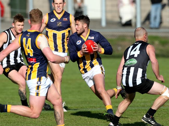 Cam McRorie (centre) was one of only four players to feature in every game for Rupertswood this year. Picture: Hamish Blair