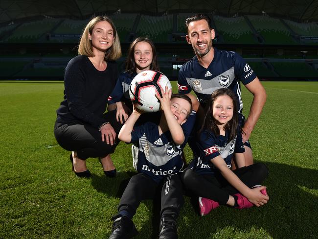 Carl Valeri (right) poses for a photograph with his partner Whitney (left) and kids Isabel (centre), Francesco (bottom) and Jasmin (bottom right) on the field at AAMI Park in Melbourne, Friday, April 12, 2019. Melbourne Victory midfielder Carl Valeri has announced his retirement today. (AAP Image/James Ross) NO ARCHIVING
