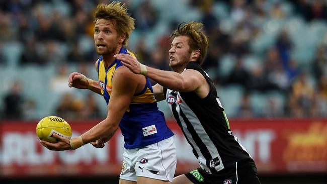 Mark LeCras is tackled by Rupert Wills at the MCG during Round 19.