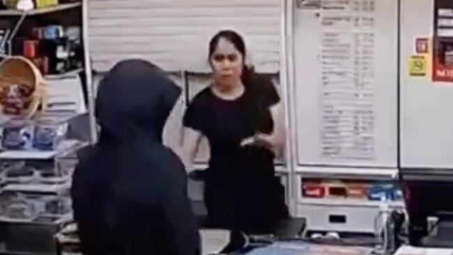 Frightening security vision has captured the moment a machete-wielding robber stormed a North Adelaide convenience store and terrorised a worker. Picture: 7NEWS,