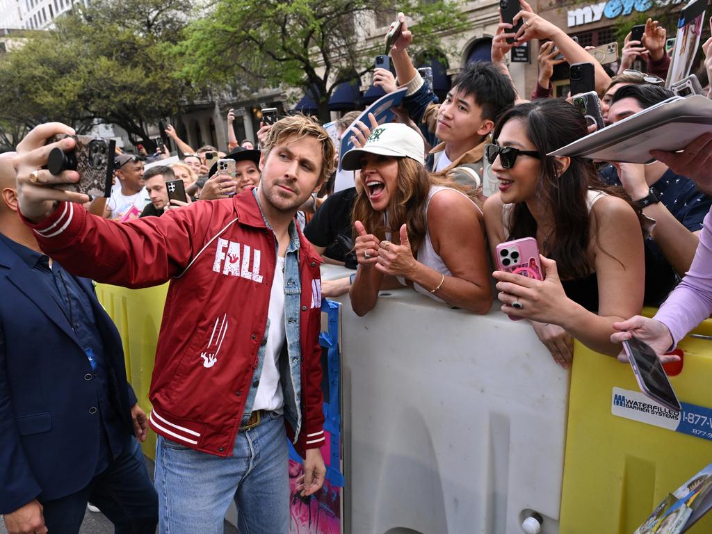 Ryan Gosling takes photos with fans outside the premiere of the SXSW premiere of 