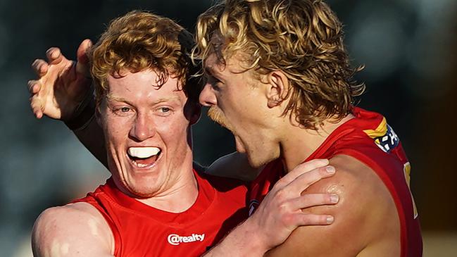 Hugh Greenwood and Matt Rowell enjoy a goal from the Round 2 rising star.