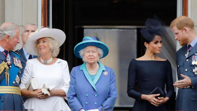 (FILES) In this file photo taken on July 10, 2018 (L-R) Britain's Prince Charles, Prince of Wales, Britain's Camilla, Duchess of Cornwall, Britain's Queen Elizabeth II, Britain's Meghan, Duchess of Sussex and Britain's Prince Harry, Duke of Sussex, stand on the balcony of Buckingham Palace to watch a military fly-past to mark the centenary of the Royal Air Force (RAF). - Britain's Prince Harry will relinquish his honorary military appointments and patronages after confirming to Queen Elizabeth II that he and wife Meghan Markle will not return as working royals, Buckingham Palace announced on February 19, 2021. (Photo by Tolga AKMEN / AFP)