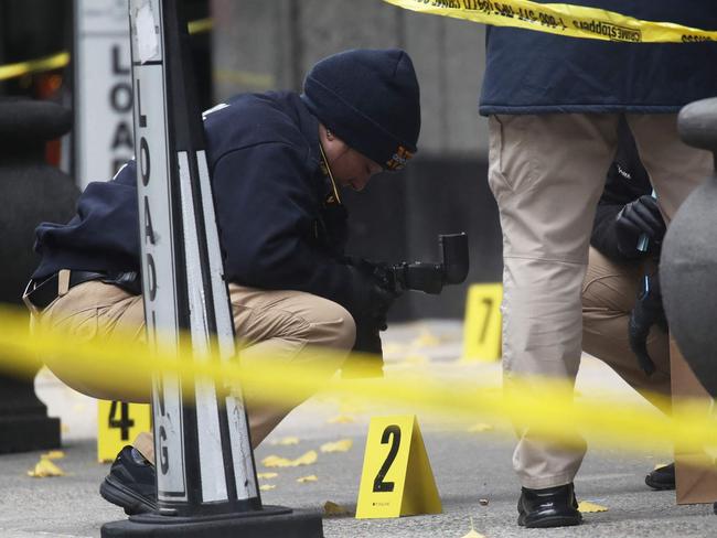 NEW YORK, NEW YORK - DECEMBER 04: Police place bullet casing markers outside of a Hilton Hotel in Midtown Manhattan where United Healthcare CEO Brian Thompson was fatally shot on December 04, 2024 in New York City. Brian Thompson was shot and killed before 7:00 AM this morning outside the Hilton Hotel, just before he was set to attend the company's annual investors' meeting.   Spencer Platt/Getty Images/AFP (Photo by SPENCER PLATT / GETTY IMAGES NORTH AMERICA / Getty Images via AFP)