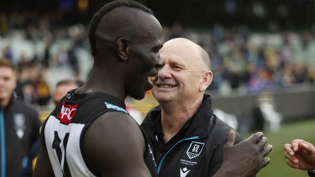 MELBOURNE, AUSTRALIA - MAY 28: Aliir Aliir of the Power and Port Adelaide Senior Coach, Ken Hinkley embrace after the round 11 AFL match between Richmond Tigers and Yartapuulti / Port Adelaide Power at Melbourne Cricket Ground, on May 28, 2023, in Melbourne, Australia. (Photo by Darrian Traynor/AFL Photos/via Getty Images)