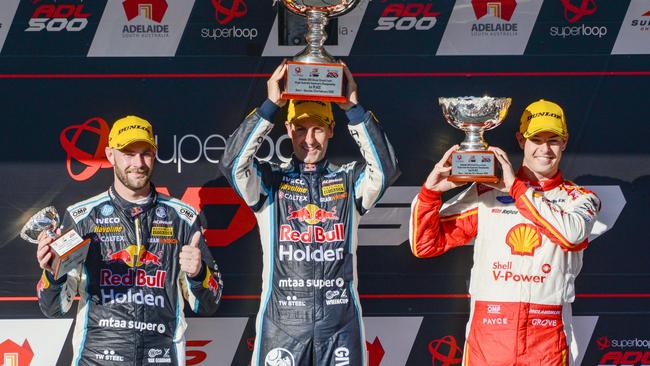 Rad Bull Racing driver Jamie Whincup, centre, holds the winners trophy with second place getter Scott McLaughlin, right, and third place Shane van Gisbergen after winning race one at the Superloop Adelaide 500 on Saturday. Picture: Brenton Edwards