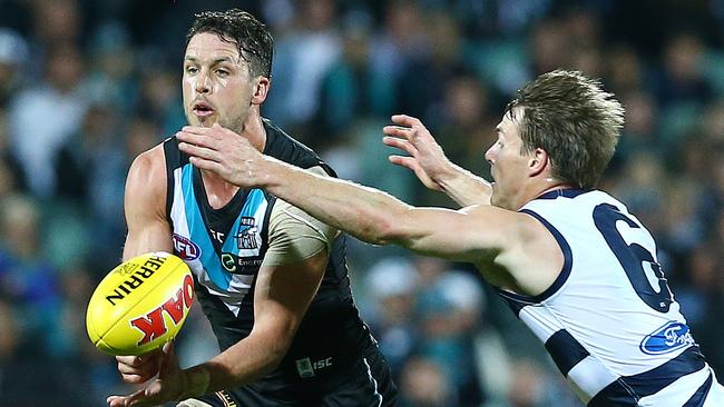 AFL - Port Adelaide v Geelong at Adelaide Oval. Travis Boak gets his handpass away from Lincoln McCarthy. Picture Sarah Reed