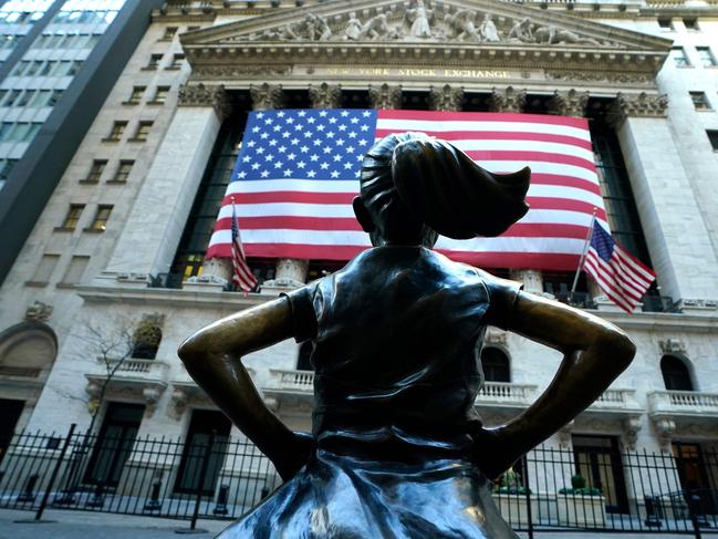 The âFearless Girlâ a bronze sculpture by Kristen Visbal, stands across from the New York Stock Exchange (NYSE) building in the Financial District in New York City on November 6, 2024. Wall Street stocks surged in opening trading on Wall Street Wednesday after US voters sent Donald Trump back to the White House and delivered him a Republican Senate. Major indices were up 1.8 percent or more in the early going as hopes about expected tax cuts and regulatory easing more than offset worries about higher tariffs. (Photo by TIMOTHY A. CLARY / AFP)