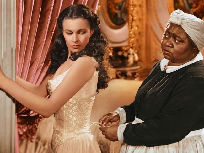 A scene from 1939 film Gone With The Wind showing Scarlett (Vivien Leigh) being laced into a traditional boned corset by Mammy (Hattie McDaniel).