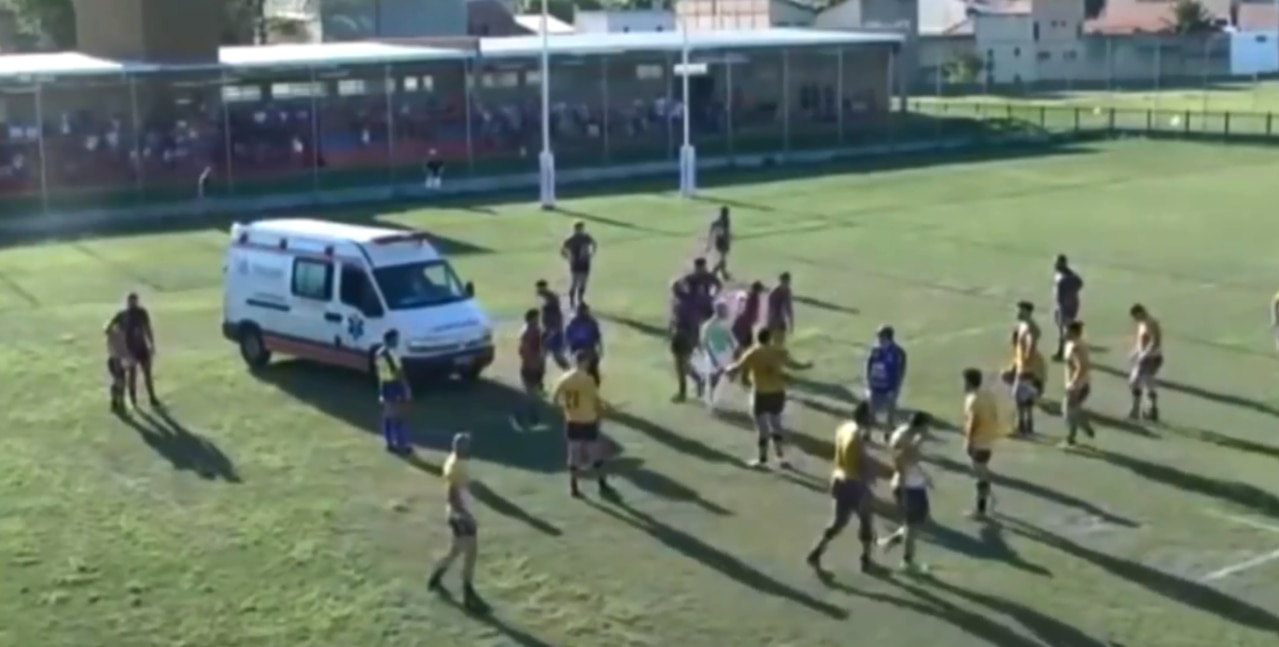 An ambulance interrupts play during a rugby game in Brazil.