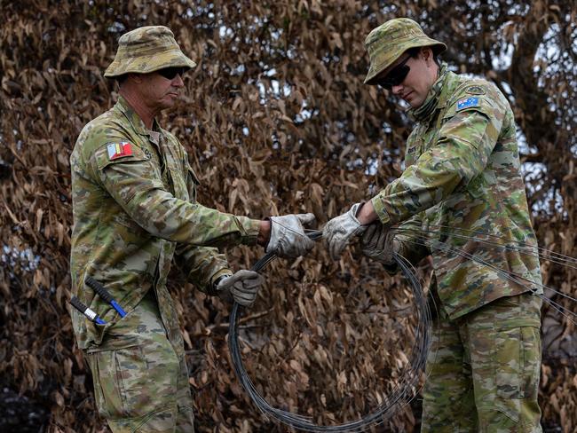 Australian Army Reservists from Central Queensland University Sergeant Stephen Oberg (left) and Private Andrew Bryan clear fire damaged fencing on Kangaroo Island during Operation Bushfire Assist. Picture: Shane Cameron.