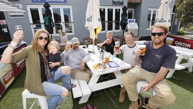 Beach Hotel Ali Stern, [holding Skylar, 17 months], Mark Ramsbottom, hotel owner Jamie Collins, Kahil Williams and Sam Beel sit in the hotel’s expanded dining area in 2021. Picture: Alex Coppel.