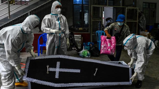 Volunteers prepare to transfer the dead body of a suspected Covid-19 victim to a cemetery, in Taungoo district. Picture AFP