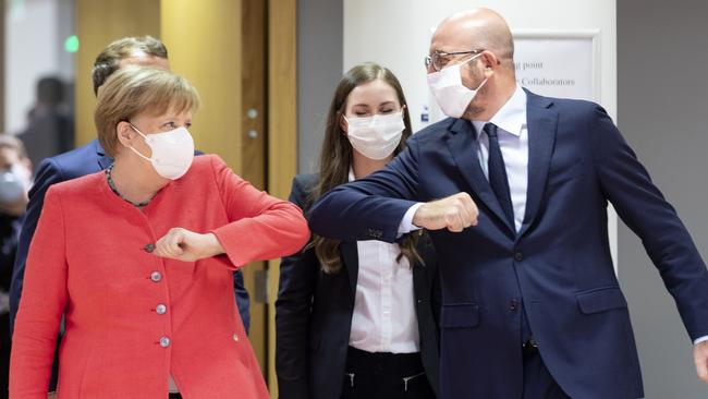 German Chancellor Angela Merkel elbow bumps European Council president Charles Michel in Brussels on Saturday. Picture: Getty Images